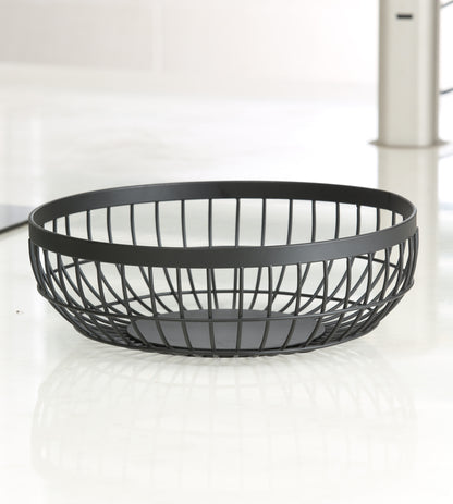 Empty matte black round wire fruit basket seen from the side, showing the crossed-wire lattice sides, wide flat rim band and solid round base