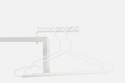 Fold-out hanging arms on the white 3-tier airer holding shirts on hangers