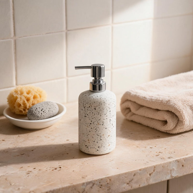 A speckled terrazzo and cement WarmyNest soap dispenser
